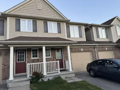 a house with a car parked in front of it at Gorgeous 3-Bedroom 3Bathroom house in Kitchener