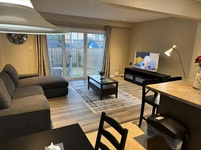 a living room with a couch and a table at Gorgeous 3-Bedroom 3Bathroom house in Kitchener