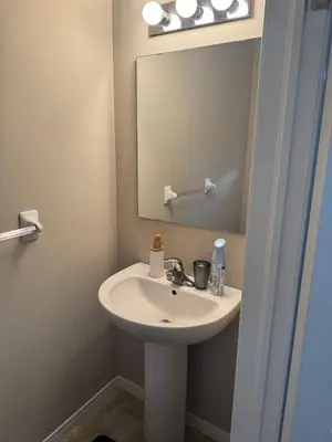 a bathroom with a sink and a mirror at Gorgeous 3-Bedroom 3Bathroom house in Kitchener