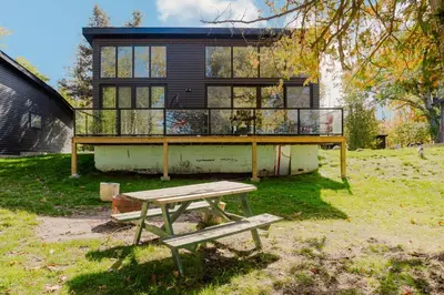 a house with a picnic table in front of it at Lakefront Englewood Villas Private BBQ and Lakeview in Lakefield