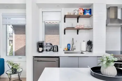 a kitchen with a sink and a counter top at Chic 3BR Ossington Hub Near Subway & Shops in Toronto