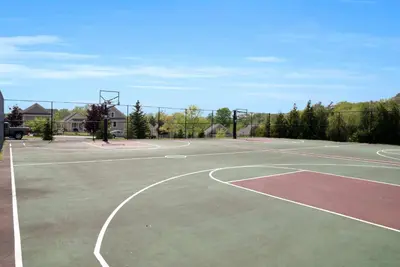 a tennis court with a basketball hoop at The Juniper - 43 Butternut in Cherry Valley