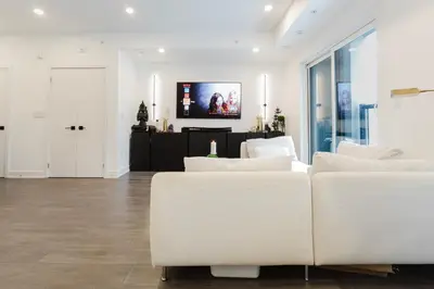 a living room with white furniture and a flat screen tv at Luxury Elegant Full house Escape Premium Comfort in Mississauga