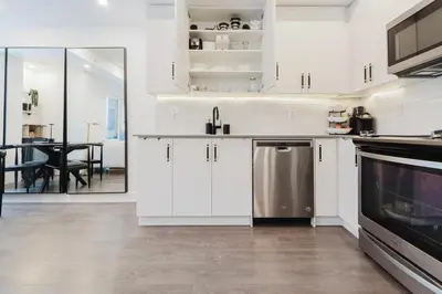 a kitchen with white cabinets and a stainless steel dishwasher at Luxury Elegant Full house Escape Premium Comfort in Mississauga
