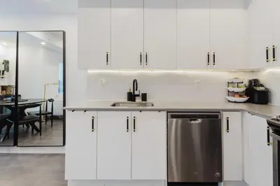 a kitchen with white cabinets and a stainless steel dishwasher at Luxury Elegant Full house Escape Premium Comfort in Mississauga