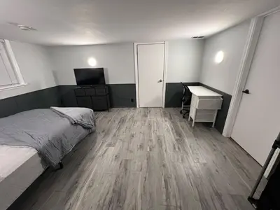 a bedroom with a bed and a desk and a computer at Prime Location Studio with Separate amenities in London