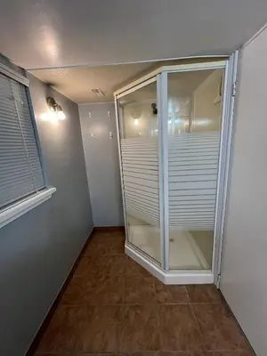 a room with a glass door and a window at Prime Location Studio with Separate amenities in London