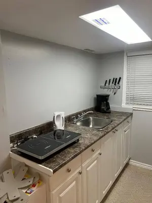 a kitchen with a sink and a counter top at Prime Location Studio with Separate amenities in London
