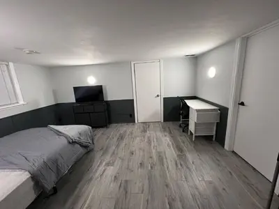 a bedroom with a bed and a desk and a television at Prime Location Studio with Separate amenities in London