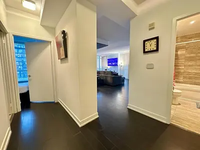 a living room with a clock on a white wall at Dreamspace 3 Bdrms with 1 Parking in Toronto