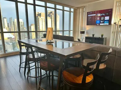 a table and chairs in a room with a large window at Dreamspace 3 Bdrms with 1 Parking in Toronto