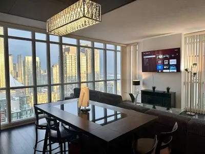 a living room with a couch and a table with chairs at Dreamspace 3 Bdrms with 1 Parking in Toronto