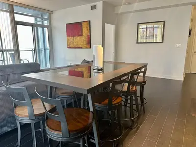 a bar with chairs and a table in a room at Dreamspace 3 Bdrms with 1 Parking in Toronto