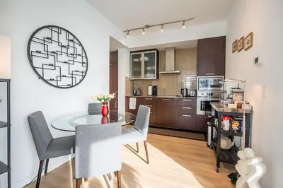 a kitchen and dining room with a table and chairs at Stunning Lake and CN Tower View with 2BR 2BA Free Parking in Toronto
