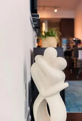 a white sculpture of a hand leaning against a wall at Stunning Lake and CN Tower View with 2BR 2BA Free Parking in Toronto