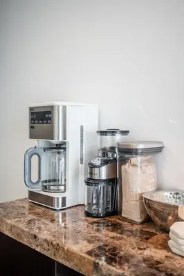 a kitchen counter with several appliances on a counter top at Stunning Lake and CN Tower View with 2BR 2BA Free Parking in Toronto