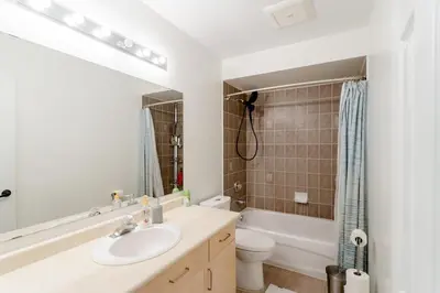 a white bathroom with a sink and a toilet at Zen-out Home in Mississauga