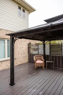 a black pergola on a deck with a chair and a table at The Bards Roost - 3BR King Ensuite Family Friendly in Stratford