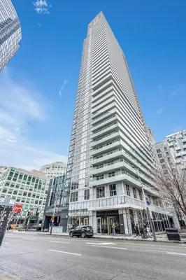 a tall building with a car parked in front of it at Eleve Toronto Residences in Toronto