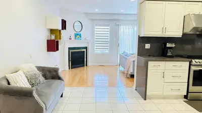 a living room with a couch and a kitchen at Bright 3BR Home in Richmond Hill free parking in Richmond Hill