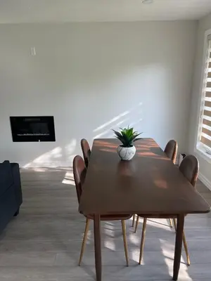 a dining room with a wooden table and chairs at Hamilton Haven Private Rooms in Hamilton