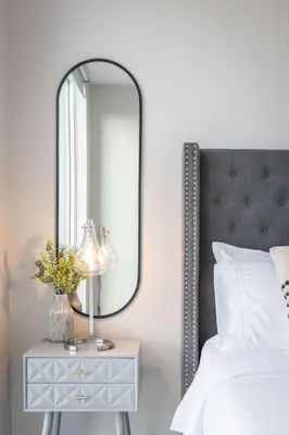 a mirror on a table next to a bed at Lovely Open Concept Friday Harbor Resort Condo in Innisfil