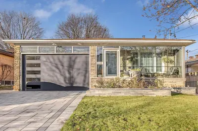 a house with a large glass door on a yard at Large Studio Room No 1 in North York in Toronto