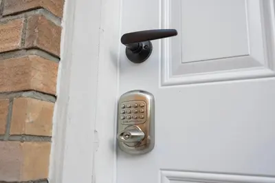 a door knob on a white door with a brick wall at Large Studio Room No 1 in North York in Toronto