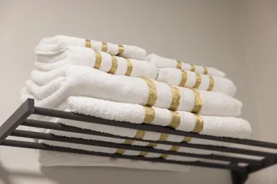 a stack of towels sitting on a rack at Large Studio Room No 1 in North York in Toronto