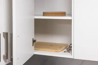 a white cabinet with a wooden cutting board in it at Large Studio Room No 1 in North York in Toronto