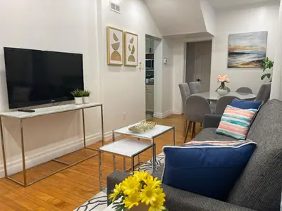 a living room with a flat screen tv and a couch at Academic Scholar Modern Apt Near Western U, Trails, Parking in London