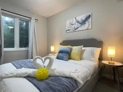 a bedroom with a bed with two swans on it at Academic Scholar Modern Apt Near Western U, Trails, Parking in London