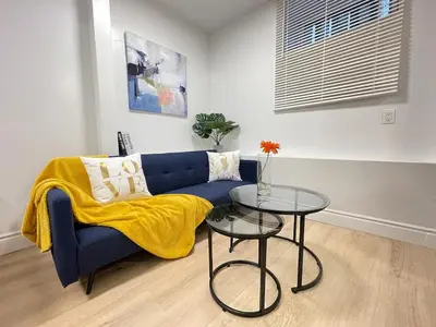 a living room with a blue couch and a table at Academic Scholar Modern Apt Near Western U, Trails, Parking in London