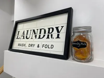 a jar of honey next to a sign on a shelf at Academic Scholar Modern Apt Near Western U, Trails, Parking in London