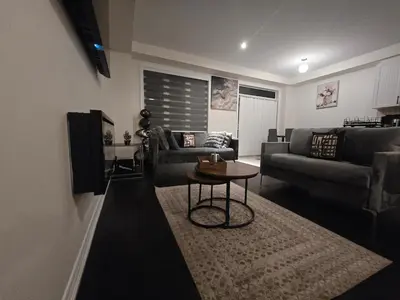 a living room with two couches and a table at Elegant 3BR Kleinburg Townhouse Free Parking Wifi Full Kitchen Laundry Near Canadas Wonderland in Vaughan