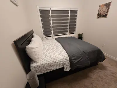 a bedroom with a bed and a window in a room at Elegant 3BR Kleinburg Townhouse Free Parking Wifi Full Kitchen Laundry Near Canadas Wonderland in Vaughan