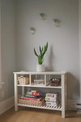 a white shelf with a potted plant and books at The Magnolia - 37 Butternut in Cherry Valley