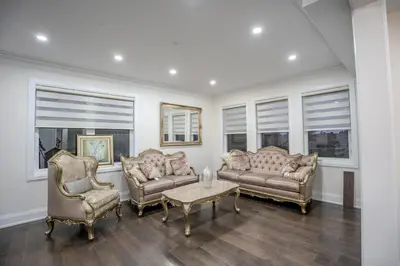 a living room with two couches and a table and chairs at Perfect Group Getaway Large House with Style in Bolton