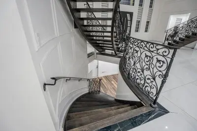 a spiral staircase in a house with wooden floors at Perfect Group Getaway Large House with Style in Bolton