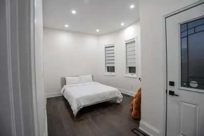 a white room with a bed and a window at Perfect Group Getaway Large House with Style in Bolton