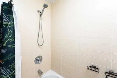 a bathroom with a shower and a toilet at Luxury 1BR Plus Den Condo With Sauna Access in Toronto