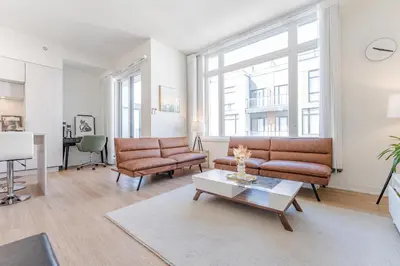 a living room with two couches and a table at Modern Family Townhouse 2 Bedrooms 3 Full Bathrooms Sleeps 6 in Richmond Hill