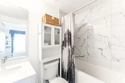 a white bathroom with a toilet and a sink at Modern Family Townhouse 2 Bedrooms 3 Full Bathrooms Sleeps 6 in Richmond Hill