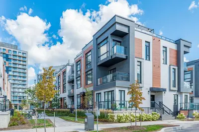 an apartment building with a balcony on a city street at Modern Family Townhouse 2 Bedrooms 3 Full Bathrooms Sleeps 6 in Richmond Hill