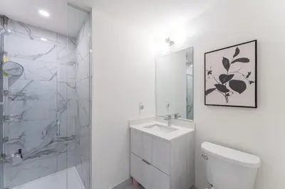 a bathroom with a toilet and a sink and a shower at Modern Family Townhouse 2 Bedrooms 3 Full Bathrooms Sleeps 6 in Richmond Hill