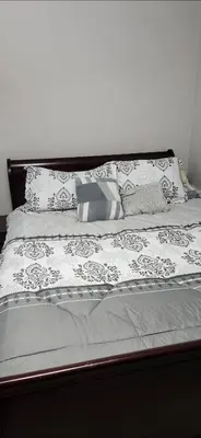 a bed with black and white sheets and pillows at Beautiful Master bedroom with private 5PC ensuite washroom in Mississauga