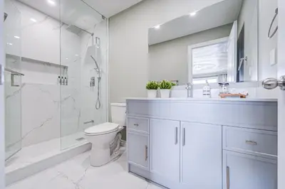 a bathroom with a shower and a toilet and a sink at Cozy Studio with 2 Beds & Private Bathroom in Toronto