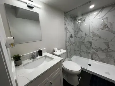a bathroom with a sink and a toilet and a shower at Beautiful Newly Built 2 Bedrooms Basement Apartment in Milton ,Sleeps 6 in Milton