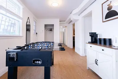 a room with a ping pong table in the middle at 2min to DT, Cowboys, Full-Kitchen, 65 inch TV in London