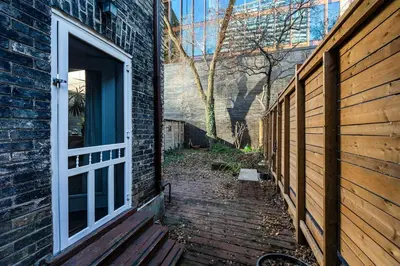 an entrance to a brick building with a wooden door at Spacious 3 Bedroom Toronto Home with Piano in Toronto